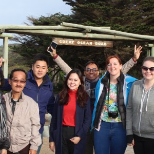 A couple posing in front of the Great Ocean Road Tours sign